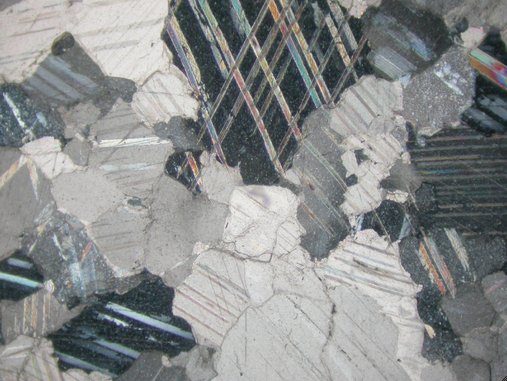 Photomicrograph (crossed polars, image width = 2.55 mm) of the petrographic thin section of the stone from Head of Mars (2nd century A.D.). The Art Institute of Chicago