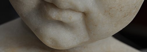 Detail showing the traces of the flat chisel used to sculpt the line extending from the corner of the mouth to the chin of Statue of a Young Boy (1st century A.D.). The Art Institute of Chicago