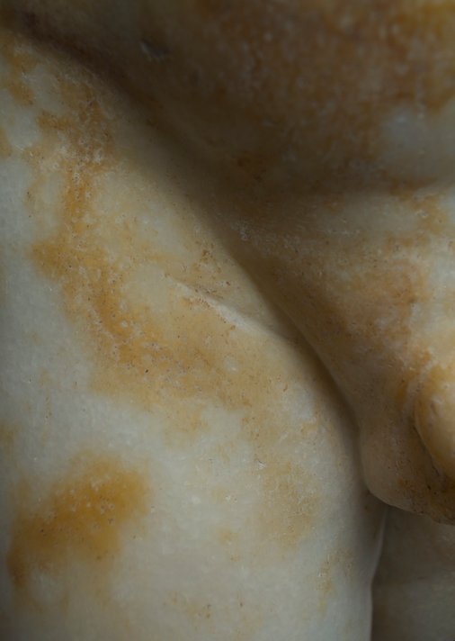 Detail showing traces of the flat chisel used to render the fleshy rolls on the inner thigh of Statue of a Young Boy (1st century A.D.). The Art Institute of Chicago