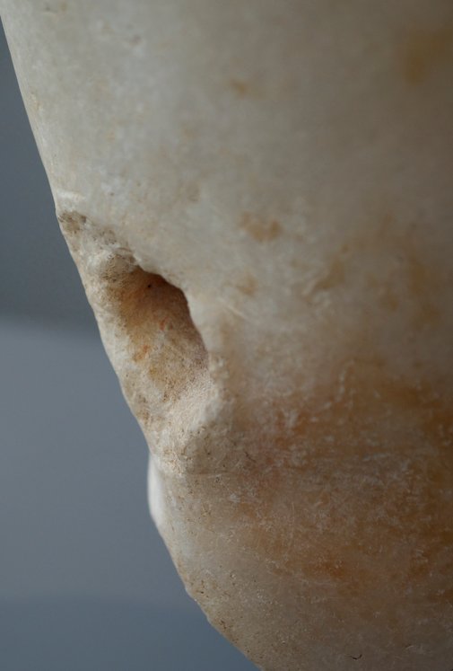 Detail showing the hole in the proper right leg of Statue of a Young Boy (1st century A.D.) showing the protuberance of stone around the outside edge. The Art Institute of Chicago