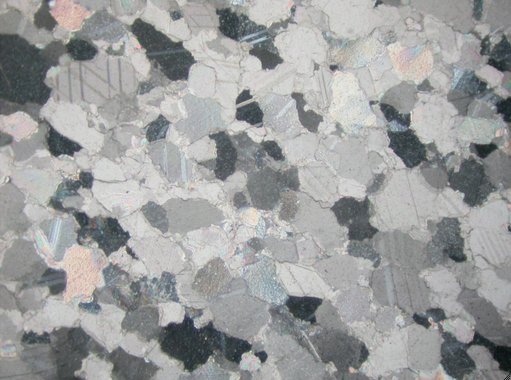 Roman Art | Online Scholarly Catalogue | Art Institute of Chicago | Photomicrograph (crossed polars, image width = 2.55 mm) of the petrographic thin section of the stone from Portrait Bust of a Woman (A.D. 140/50).