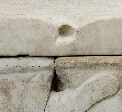 Detail showing the cavities in the proper right side of Cinerary Urn (late 1st/early 2nd century A.D.), created to accommodate a cramp. Traces of a dark material presumed to be lead are visible inside the holes. The Art Institute of Chicago, 1926.621a–b.