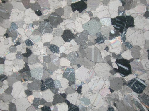 Photomicrograph (crossed polars, image width = 2.55 mm) of the petrographic thin section of the stone from the lid of Cinerary Urn (late 1st/early 2nd century A.D.). The Art Institute of Chicago, 1926.621a–b.
