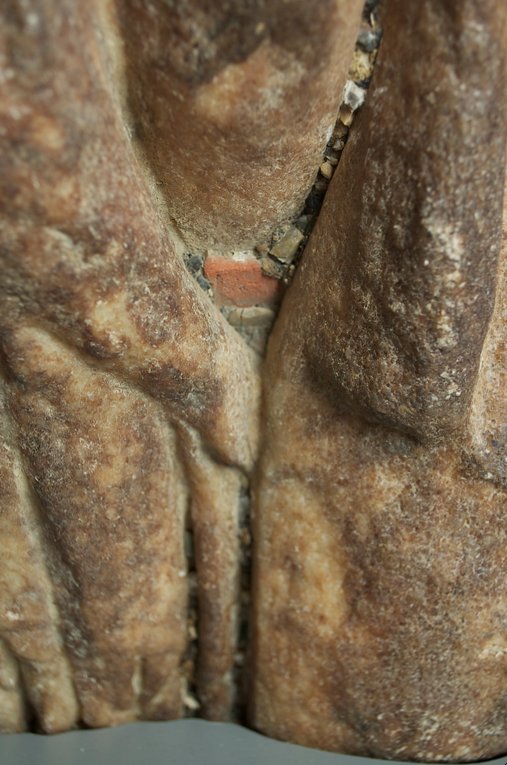 Roman Art | Online Scholarly Catalogue | Art Institute of Chicago | Detail showing detritus from burial, including a large square of terracotta, embedded in the folds of the cuirass of Fragment of a Portrait Statue of a Man (2nd century A.D.).