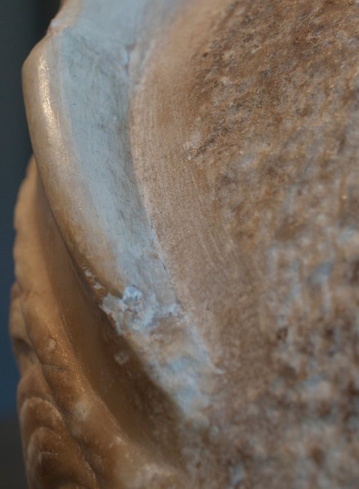 Detail of Portrait Head of a Woman (A.D. 117/38) showing the traces of a rasp visible along the channel just behind the diadem. The Art Institute of Chicago, 1962.926.
