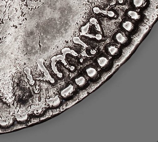 Detail showing the indistinct final few letters of the inscription on the reverse of Tetradrachm (Coin) Portraying Queen Cleopatra VII (37/33 B.C.). The Art Institute of Chicago