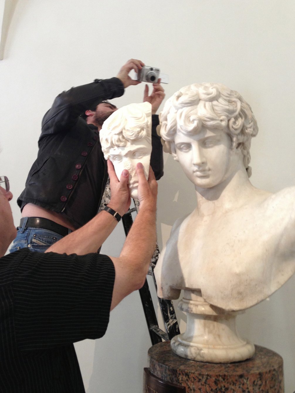 Jerry Podany, senior conservator of antiquities at the J. Paul Getty Museum, Los Angeles, displays a cast of the Art Institute of Chicago’s Fragment of a Portrait Head of Antinous